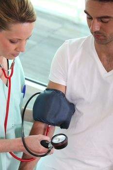 Nurse taking a man's blood pressure